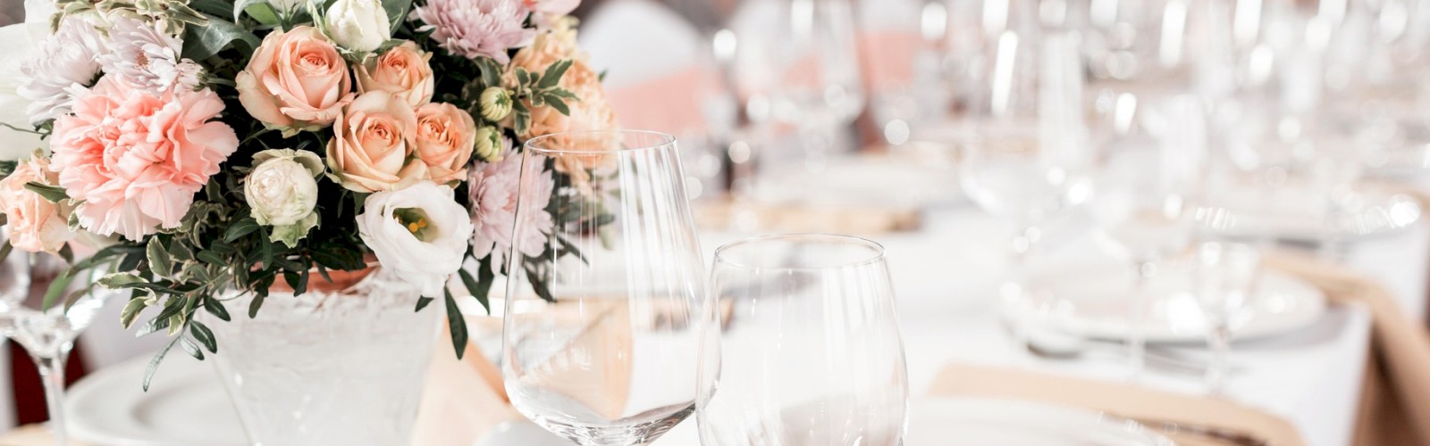 Wedding Table for 20 decorated with flowers, plates and glasses