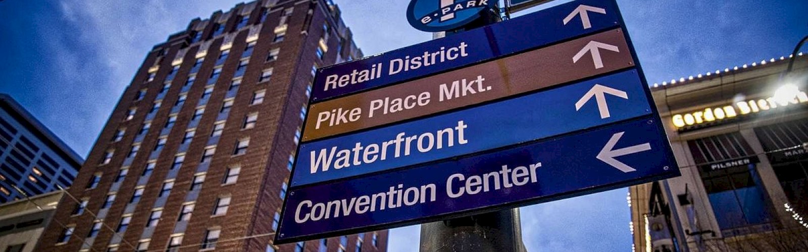 Street signs directing to the Retail District, Pike Place Market, Waterfront, and Convention Center, at 7th Ave in downtown Seattle..